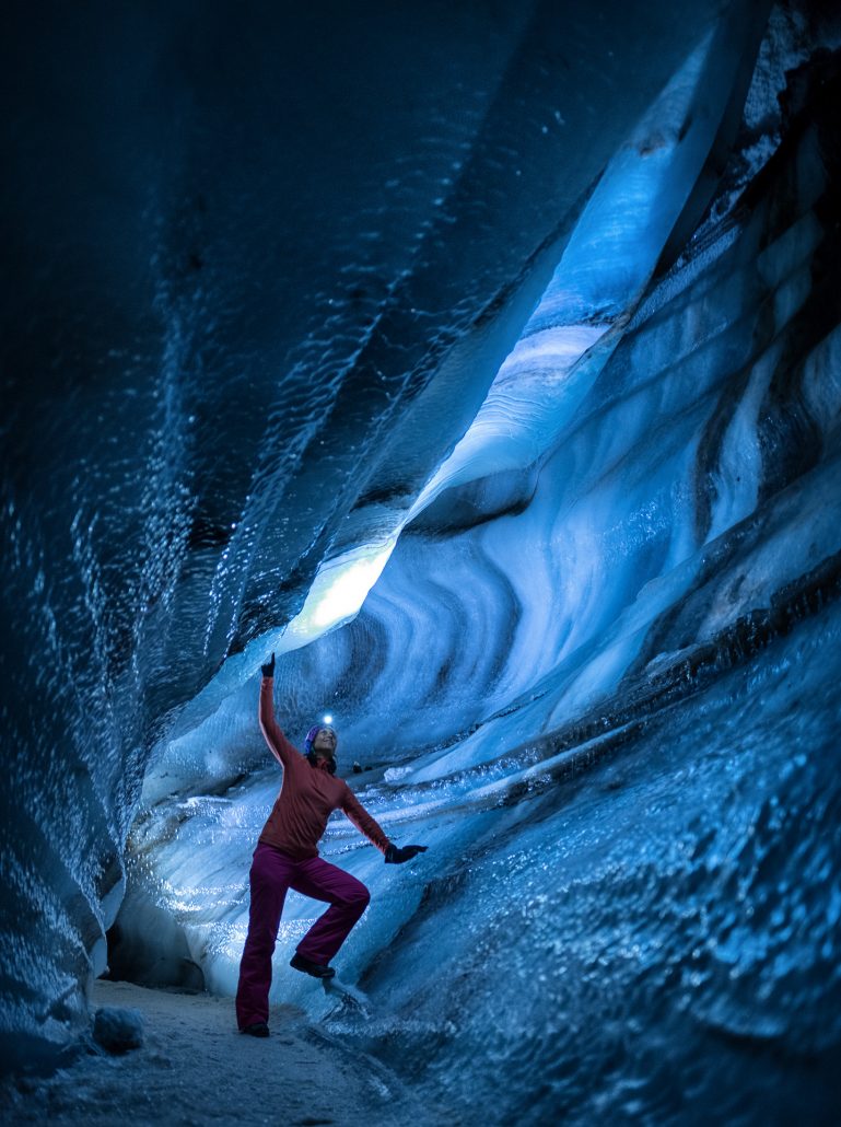 A guest exploring on of the ice caves nearby Longyearbyen